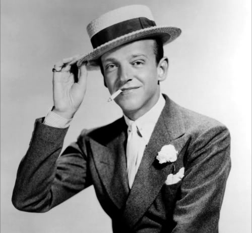 Fred Astaire, the original dandy, fully accessorized with cufflinks, collar pin and studs - not to mention carnation, pocket kerchief and boater.