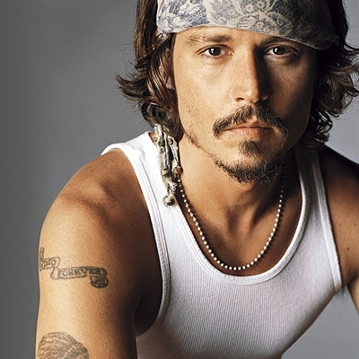 Johnny Depp channels Springsteen (bohemian beads and muscle shirt) and George Harrison (head scarf with goatee)