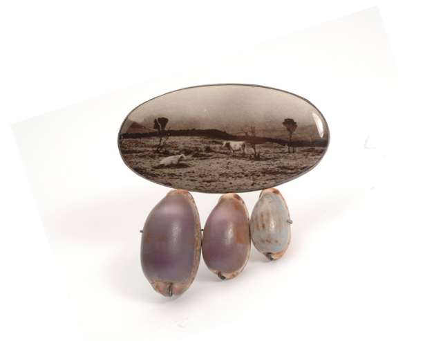 Brooch by Bettina Speckner, 2004, of artist’s photograph enameled on silver, cowrie shells, amethysts (private collection)
