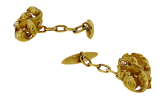 Cufflinks of 18K gold depicting a winged dragon with arrow-shaped tail and diamond in his mouth ($2,025, Aaron Faber Gallery)