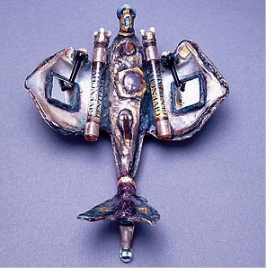 Brooch by Bianca Eshel Gershuni, 1991, of silver, shell, mirror, paint, photograph, found objects, pearl, plastic.
