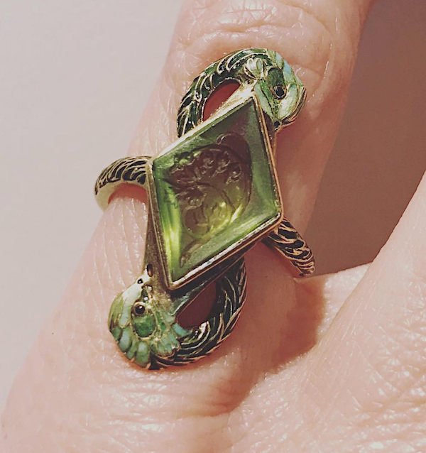Ring by René Lalique, c. 1900, of peridot carved with bleeding hearts in enameled mount depicting cranes, sold for $37,500 at Sotheby’s NY in April 2019 (photo Cathleen McCarthy)